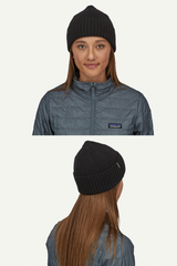 Person wearing a black beanie and gray jacket with Patagonia logo on a white background