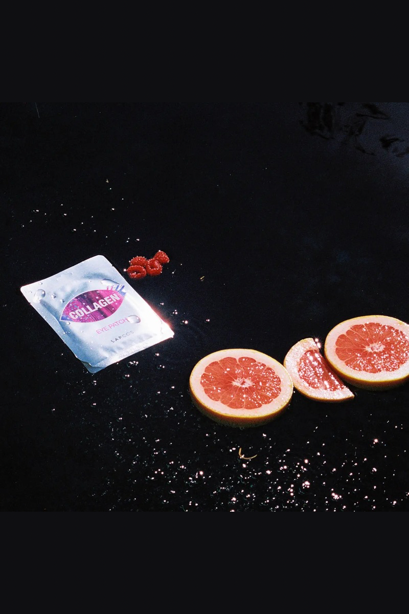 Collagen eye masks packet with grapefruit slices on a black background