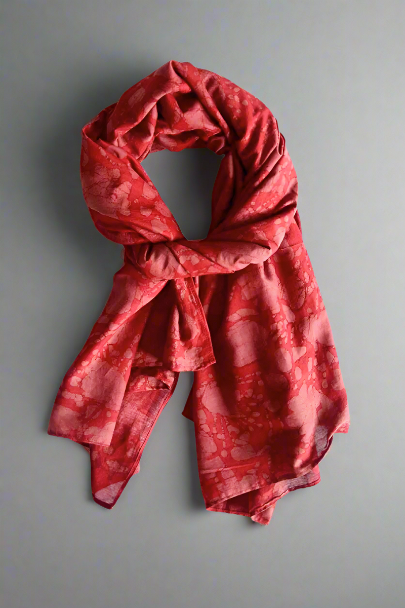 Red patterned scarf on a light gray background
