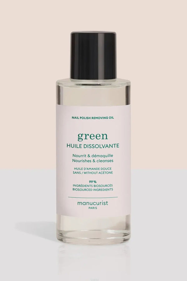 Bottle of nail polish removing oil with a white label on a beige background