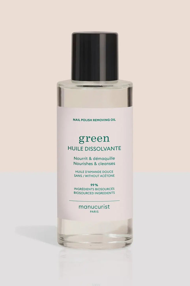 Bottle of nail polish removing oil with a white label on a beige background