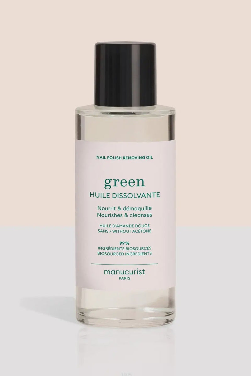 Bottle of nail polish removing oil with a white label on a beige background