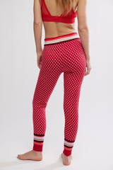 Person wearing red polka dot leggings with a white background