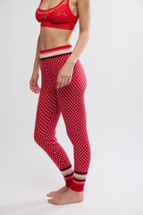 Person wearing a red polka dot loungewear set on a white background