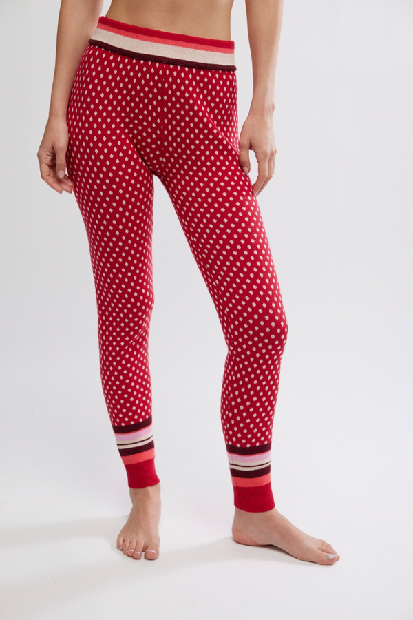 Red polka dot leggings with striped cuffs on a white background