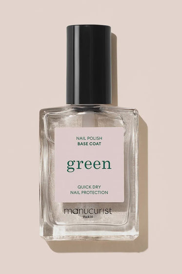 Manucurist nail polish base coat bottle on a beige background