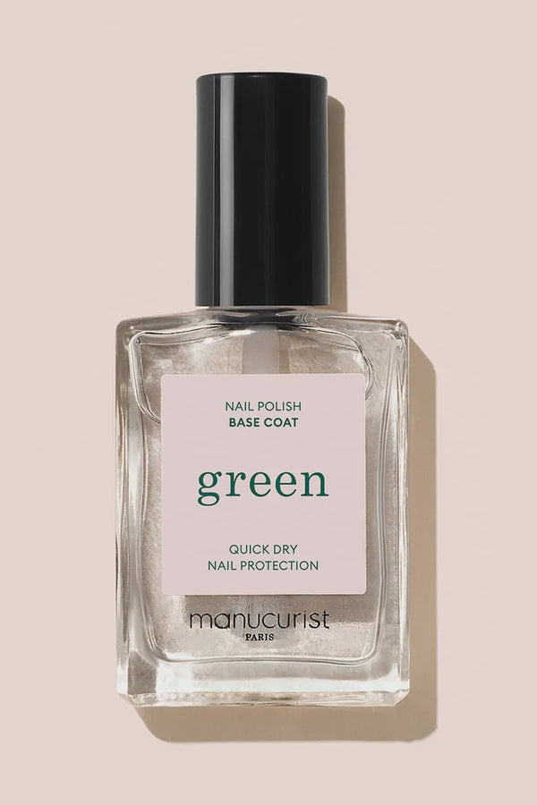 Manucurist nail polish base coat bottle on a beige background