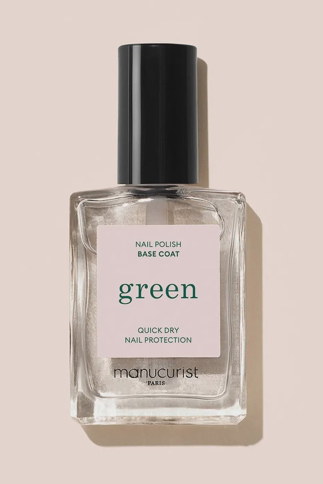 Manucurist nail polish base coat bottle on a beige background