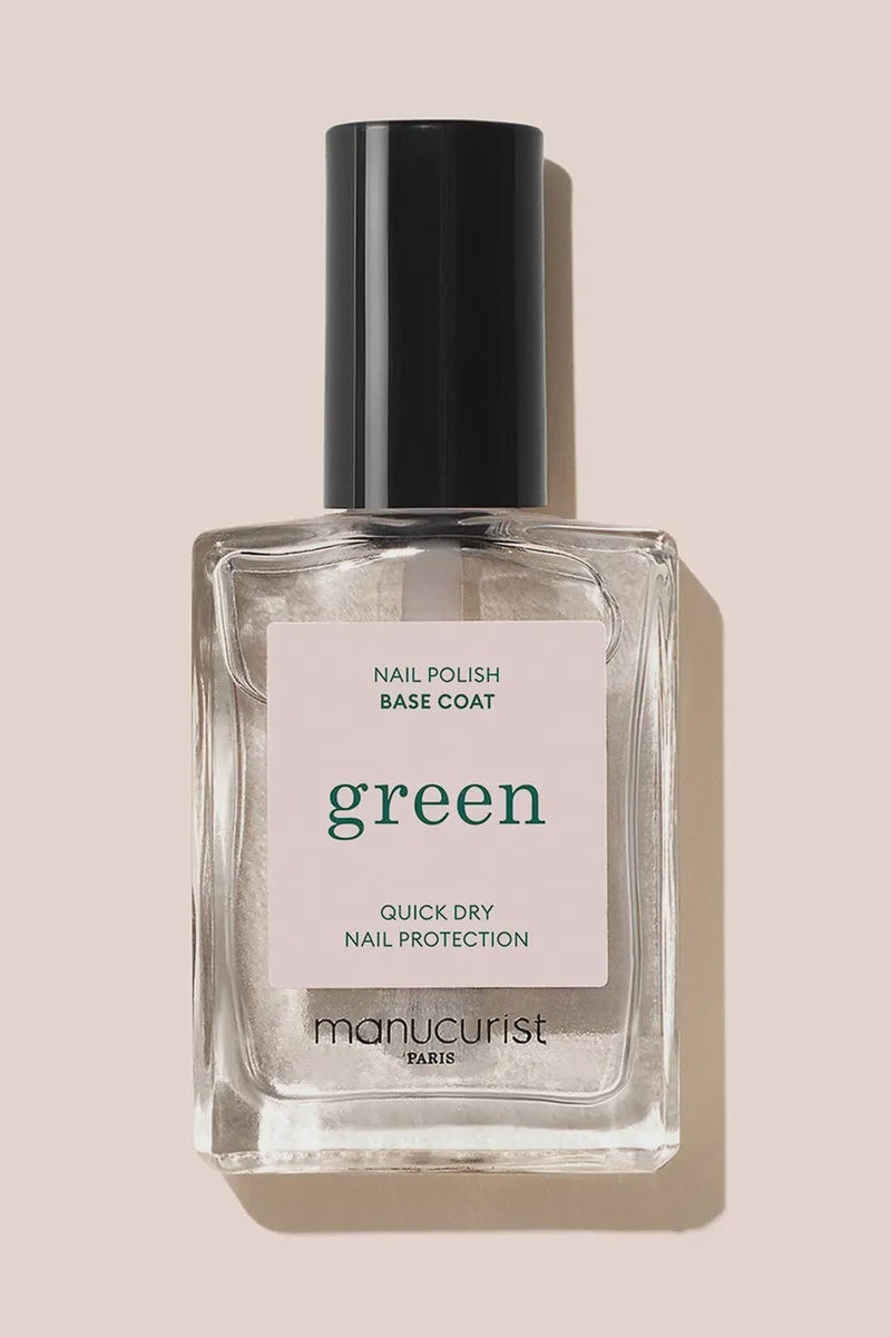 Manucurist nail polish base coat bottle on a beige background