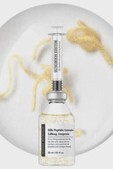 Skincare ampoule bottle with syringe on a white background