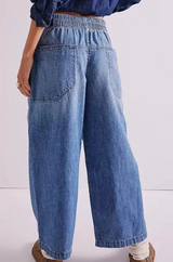 Person wearing blue jeans on a white background