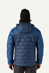 Person wearing a blue quilted jacket on a white background