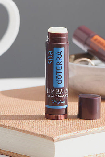 doTERRA lip balm on a book with a blurred background