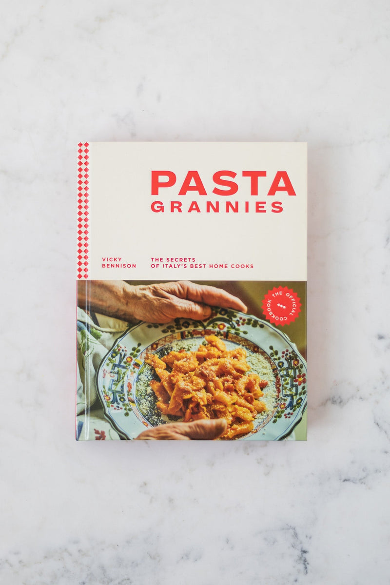 Cookbook titled 'Pasta Grannies' on a marble surface