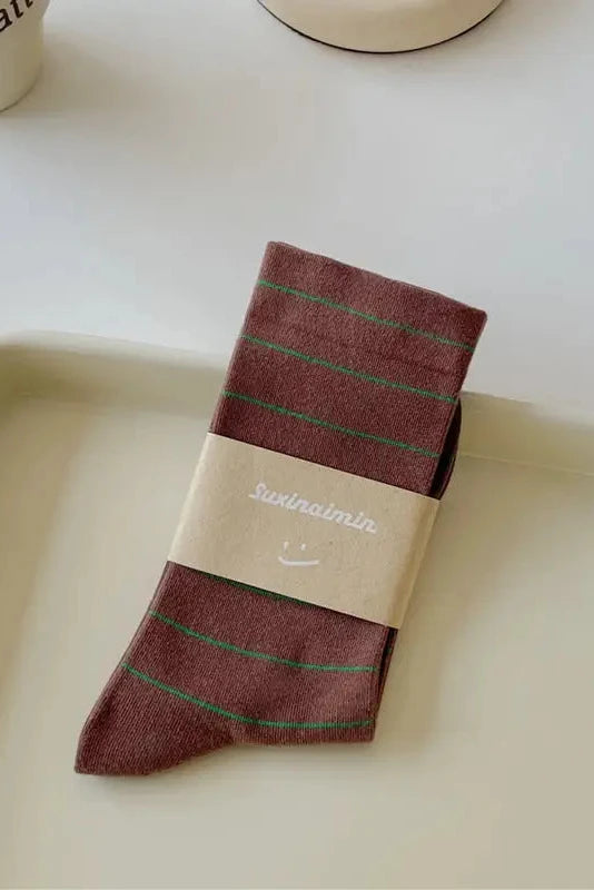 Packaged sock with brand label on a white tray