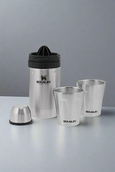 Set of Stanley stainless steel cups and a juicer on a light gray background