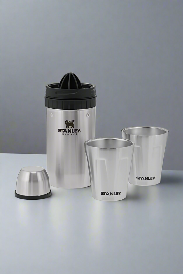 Set of Stanley stainless steel cups and a juicer on a light gray background