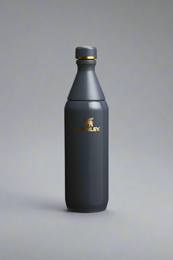 Dark blue water bottle with a gold cap on a light gray background