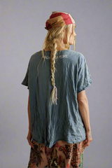 Person wearing a blue t-shirt with text on the back.
