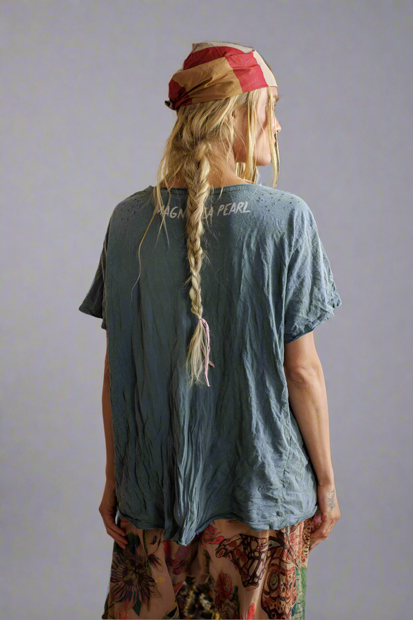 Person wearing a blue t-shirt with text on the back.