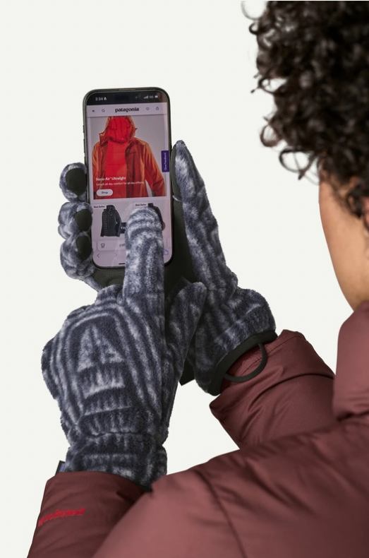 Person wearing gloves using a smartphone on a white background