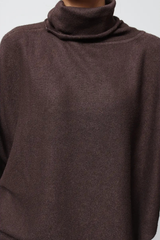 Close-up of a brown turtleneck sweater on a plain background