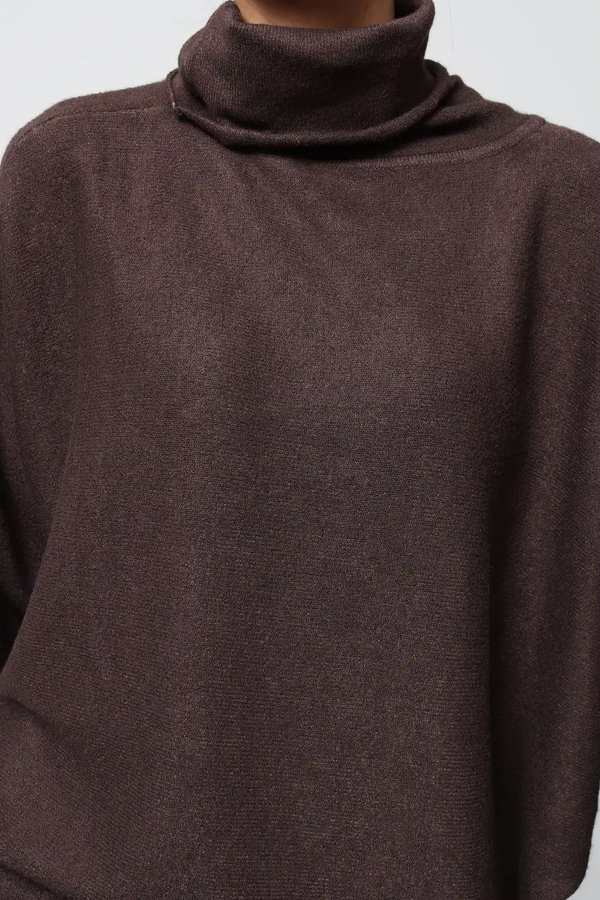 Close-up of a brown turtleneck sweater on a plain background