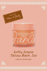 Jar of Darlin Softly Simple Tallow Balm on a pink background with decorative elements.